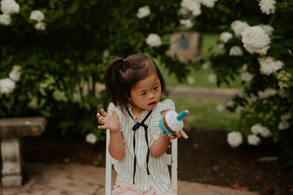 Little girl playing with cupcake Rattle, with cotton candle by Pebblechild in crochet