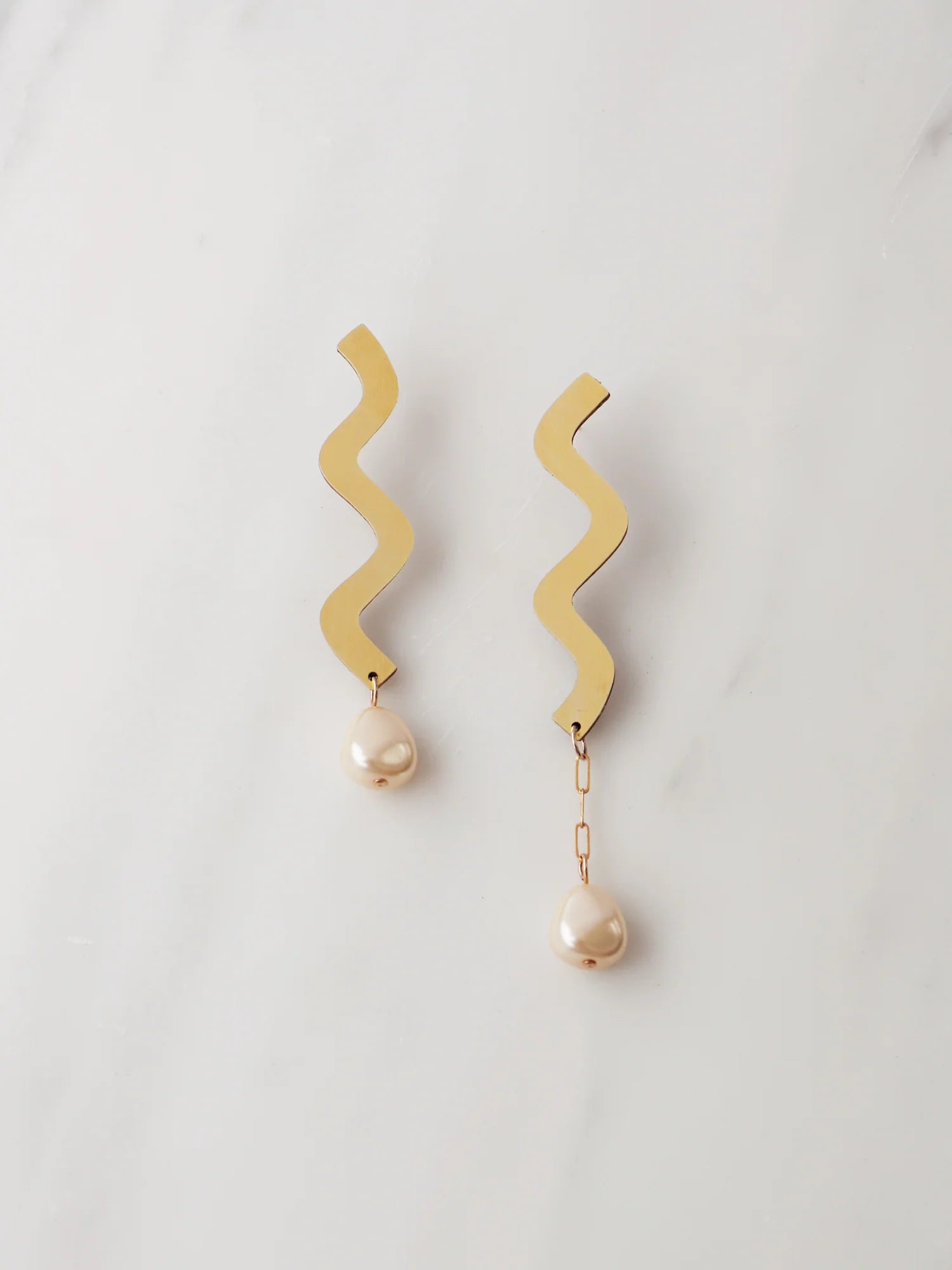 Wavy asymmetric statement earrings made in brass with Wolf & Moon's signature wood base, Czech glass baroque pearls, 14k gold-filled chain and sterling silver earring posts. 