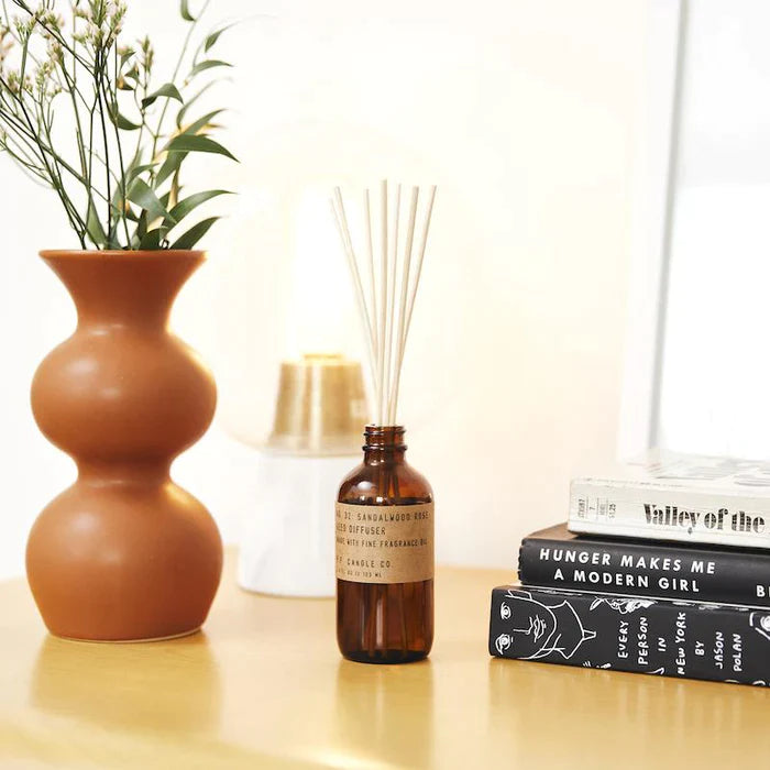 Sandalwood Rose 3 fl oz reed diffuser with fine fragrance oil in a 4 oz amber apothecary-inspired bottle with rattan reeds, by PF Candle Co.