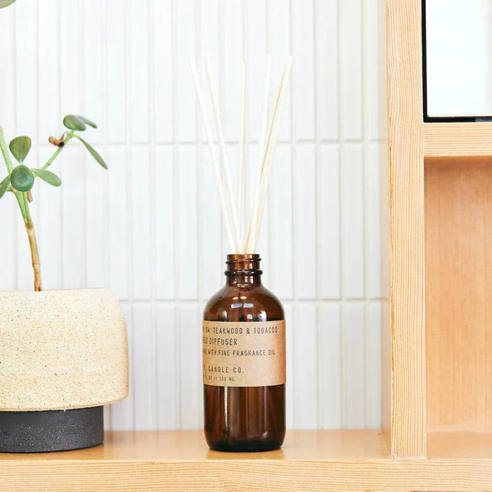 Teakwood & Tobacco 3 fl oz reed diffuser with fine fragrance oil in a 4 oz amber apothecary-inspired bottle with rattan reeds, by PF Candle Co.